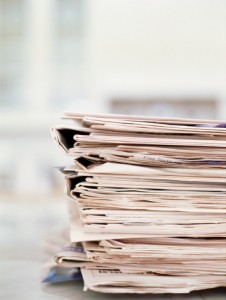 A pile of folders on a desk.